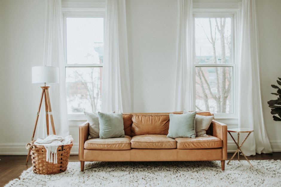 Tan leather three-seater sofa in a bright living room